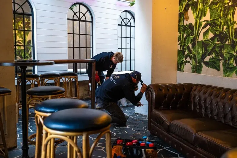 Technicians carrying out a pest treatment in a venue