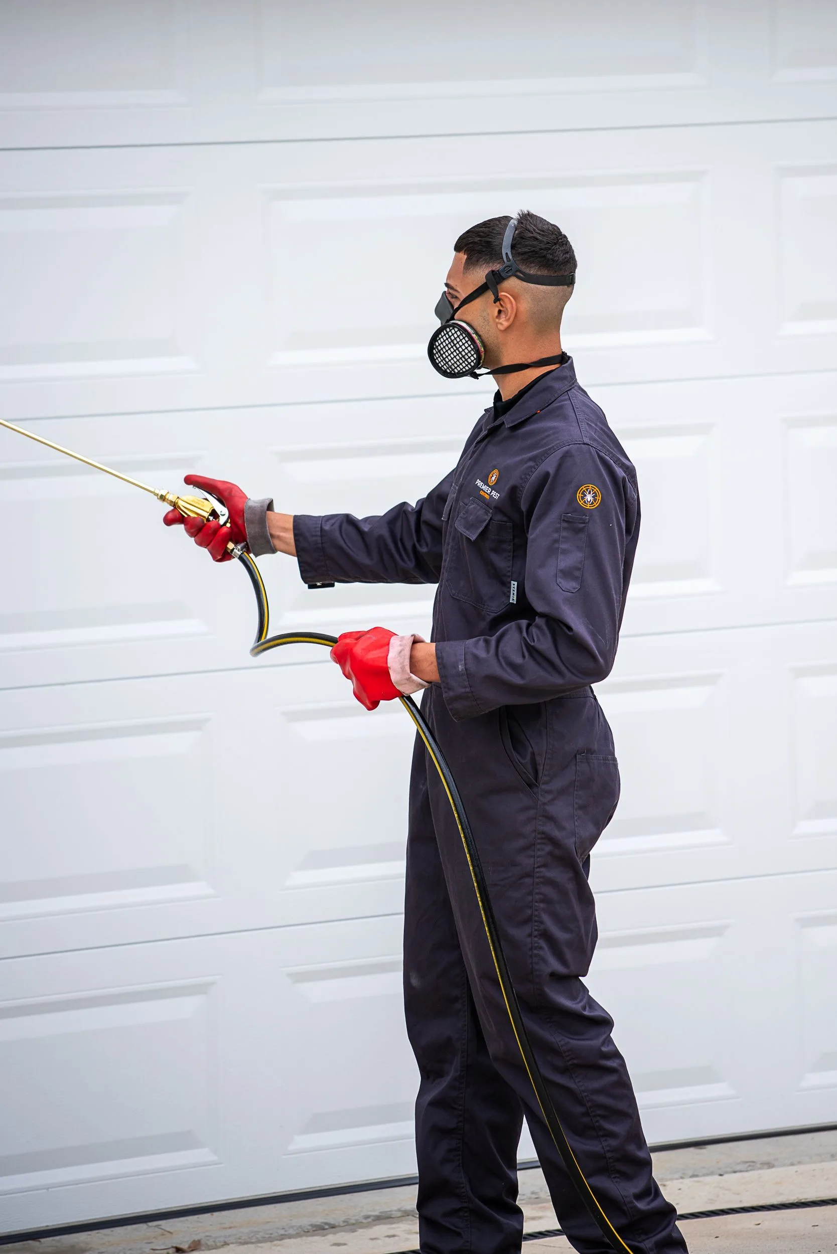 Premier Pest Control technician applying an environmentally conscious treatment